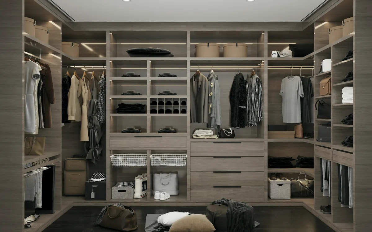 Light-filled walk-in closet with tailored pieces and shoes arranged on open shelving